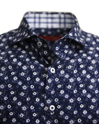 Known for our prints, this exclusive eye catching print is curated on our soft pima cotton. A stunning shade of indigo blue with white pattern is coordinated with a rich white, navy & grey plaid inside the collar stand and cuffs. Looks terrific with the sleeves down or with the Georg Roth roll showing the handsome cuff detail.
100% Cotton
Machine wash cold hang to dry or dry clean 